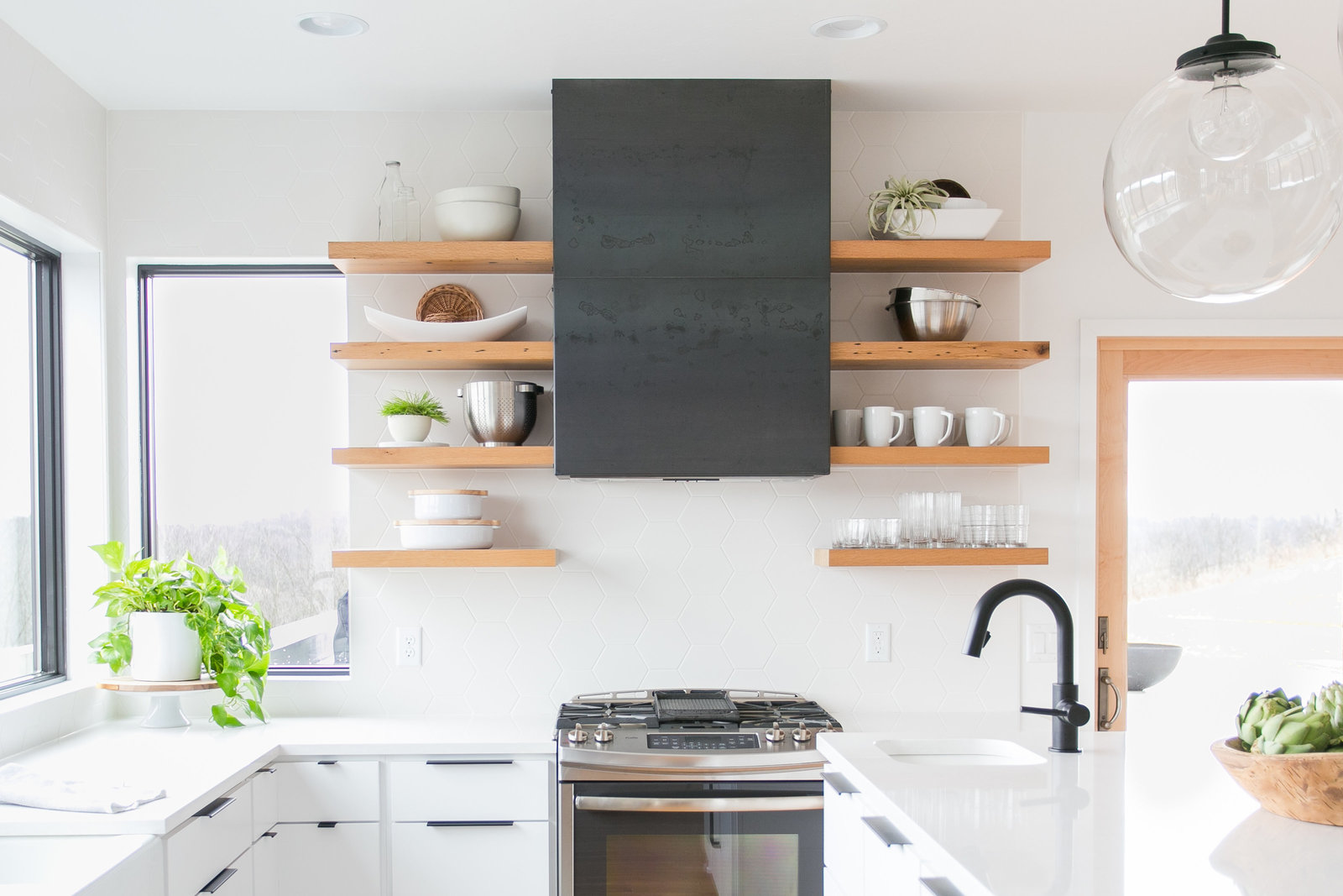 Modern, warm kitchen design.  Minimalist, white cabinets and backsplash.