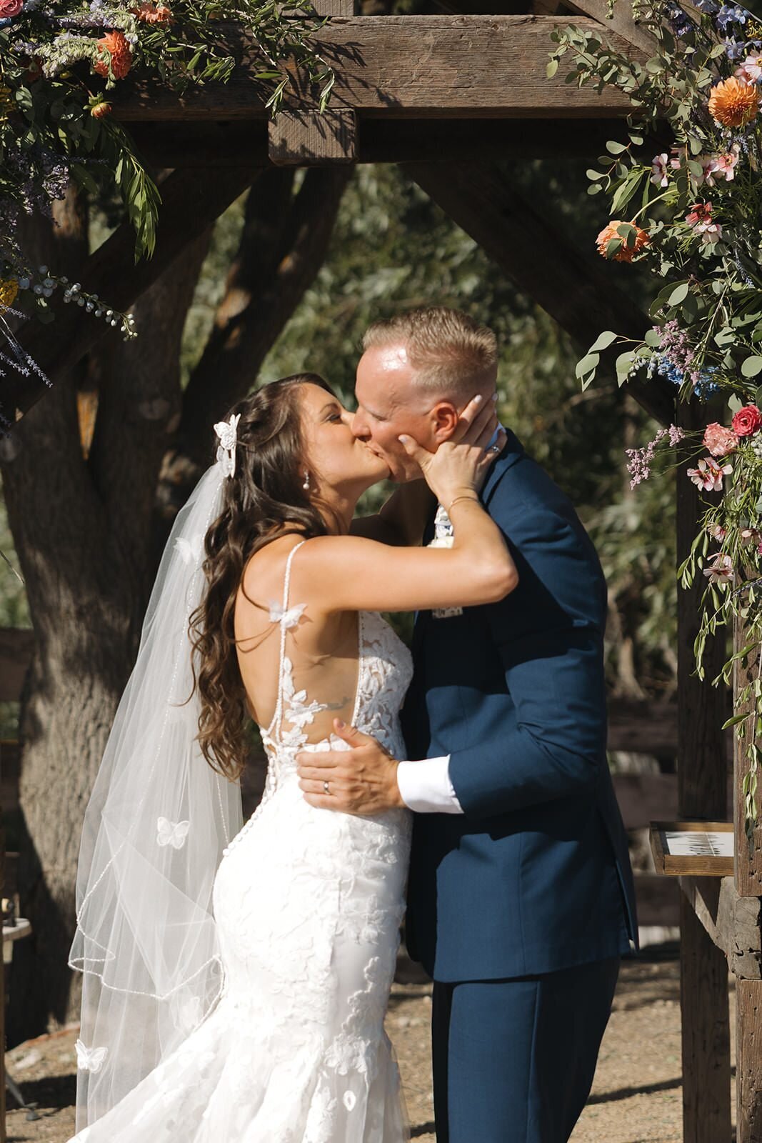 First kiss under the floral arbor