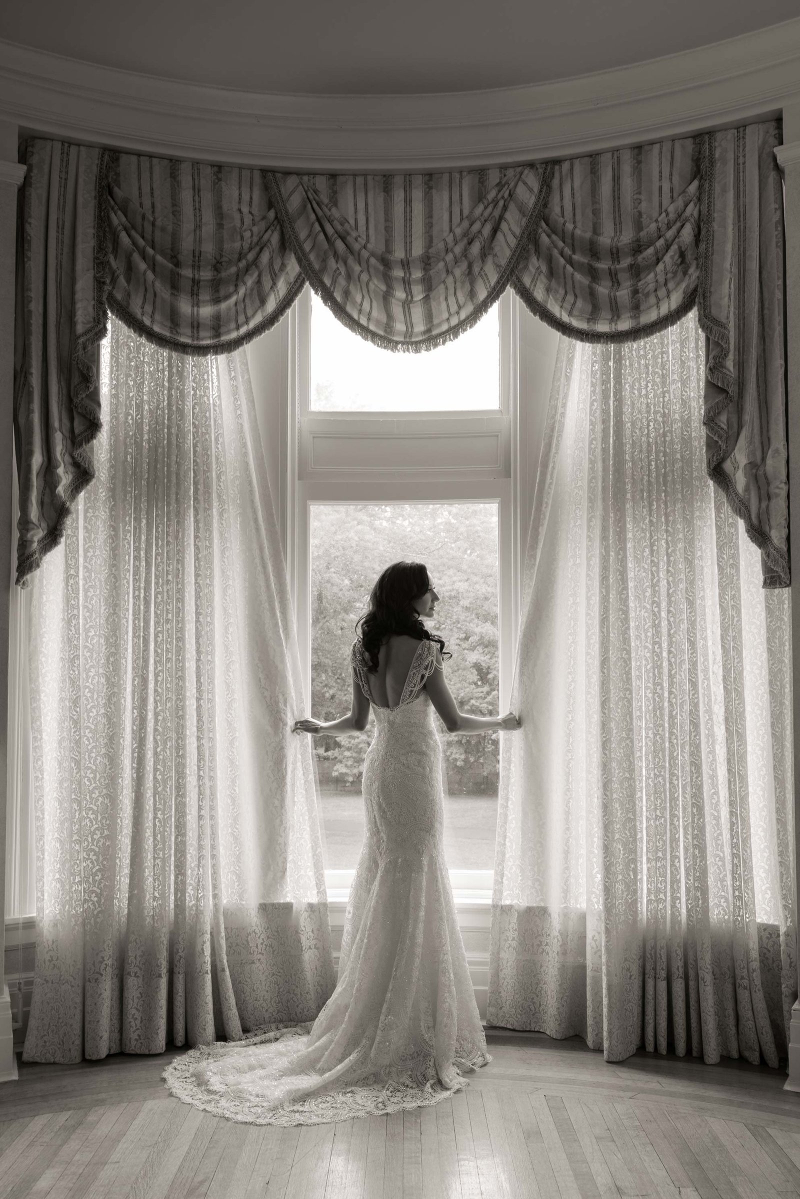 Black and white photo of the bride getting ready at Coindre Hall