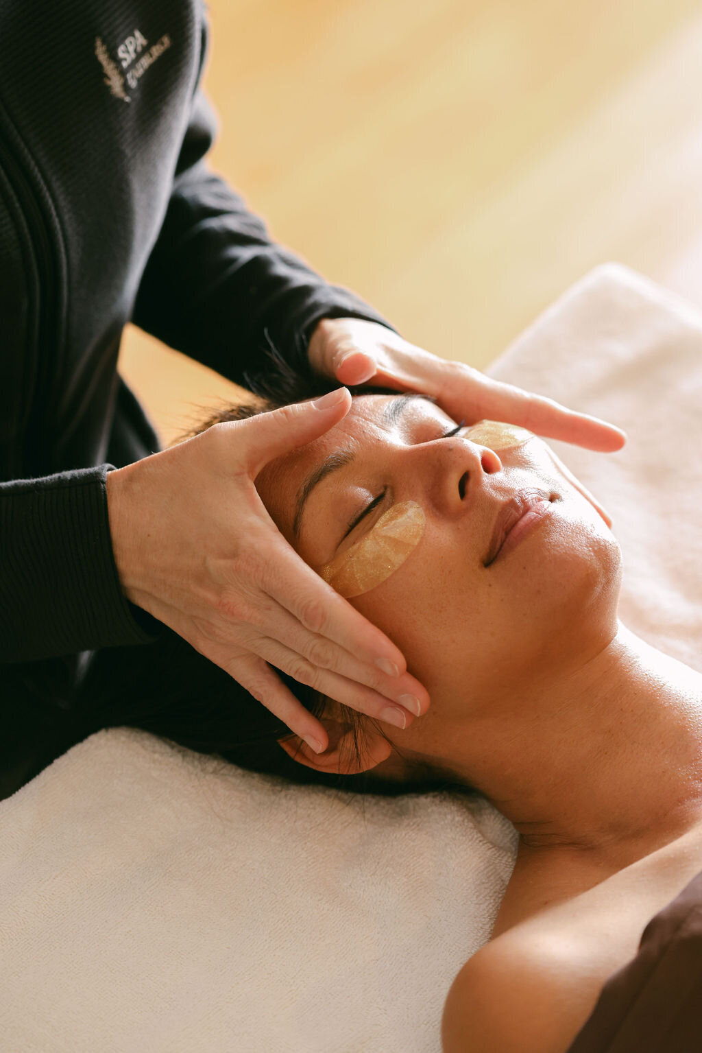 Woman getting massage facial at luxury boutique hotel