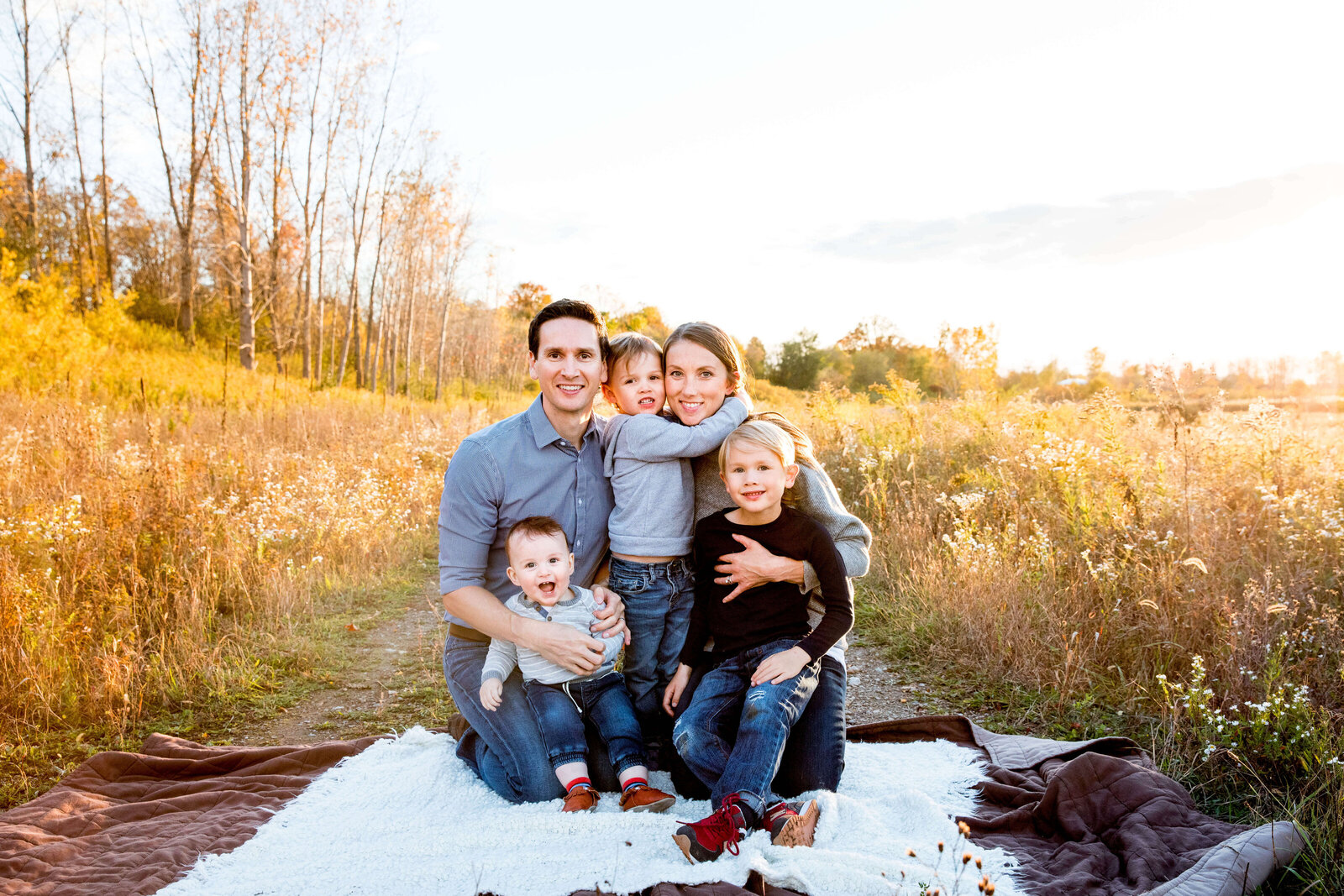 Family of five poses on blanket on conservation trail in Komoka