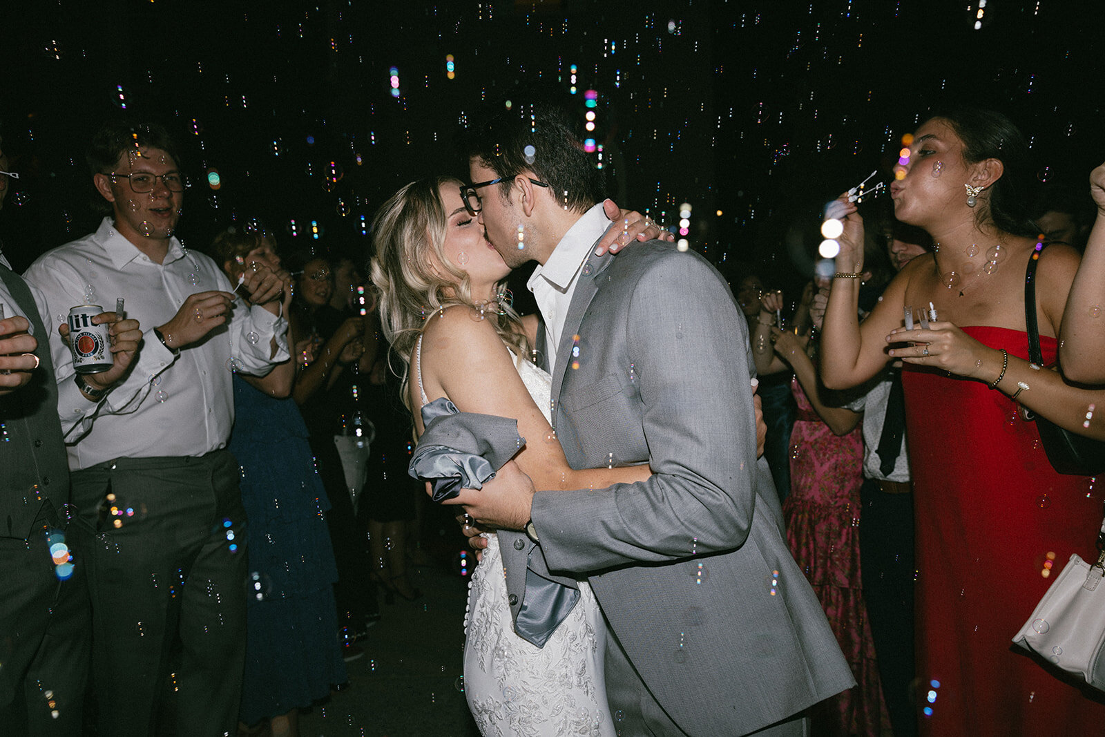 Couple embrace and kiss during their bubble getaway procession at the Cordell in Nashville, TN.