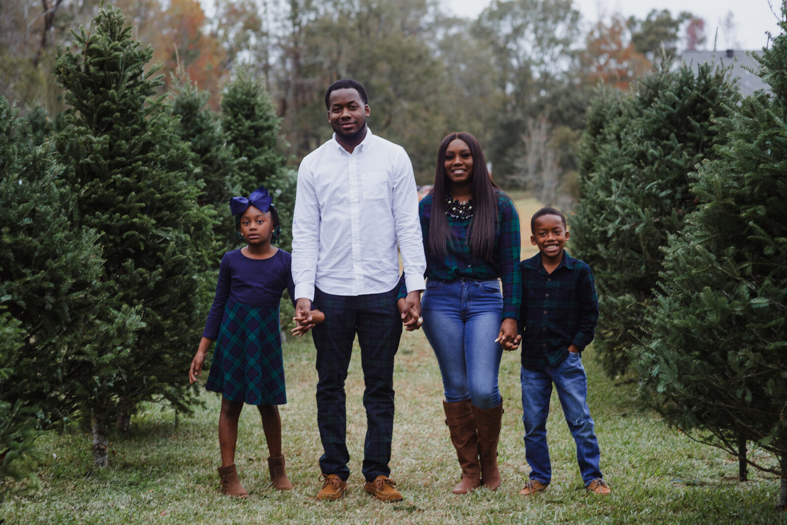 Family of 4 in a Christmas tree farm