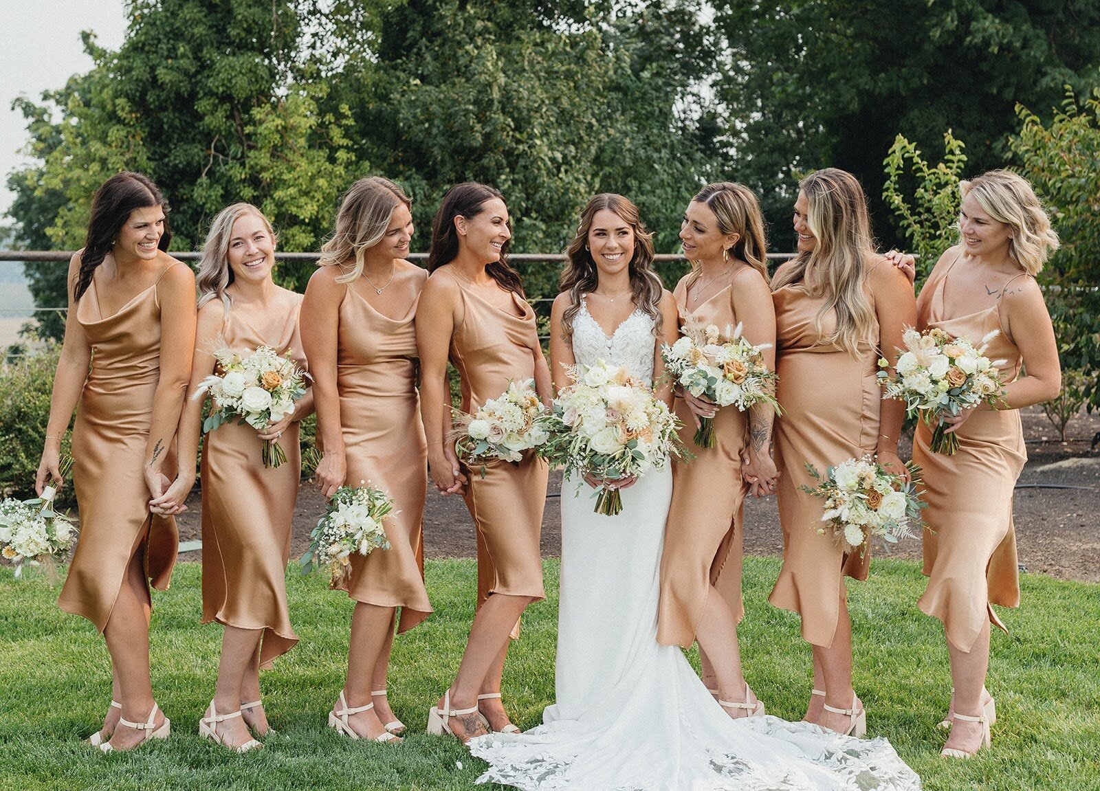 Neutral wedding color palette with bridal party and their bouquets by Flowers and Thyme.