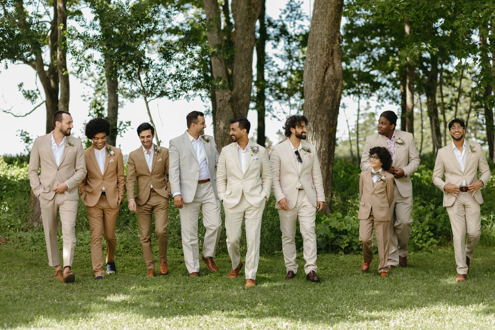 A groom is enjoying a moment with all of his groomsmen at his wedding in Prince Edward Island. 