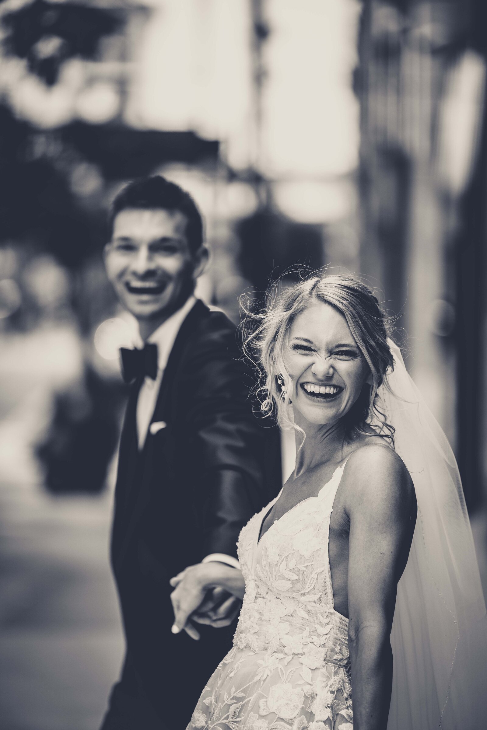 Experience the genuine joy and infectious laughter of Hailey and Peter captured during their special day. This heartwarming image showcases the couple's spontaneous laughter and the carefree spirit of their wedding celebration. Perfect for those seeking wedding inspiration that emphasizes real, unscripted moments of joy and connection, this photograph highlights the power of love and laughter in creating unforgettable memories.