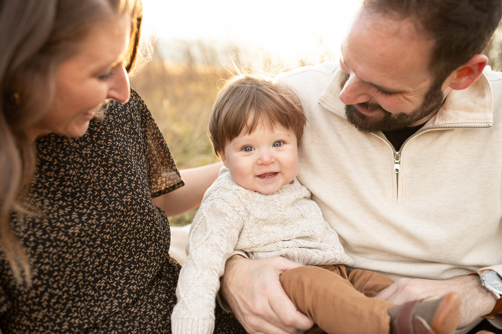 Parents looking at baby and smiling while getting photos in the Columbia River Gorge