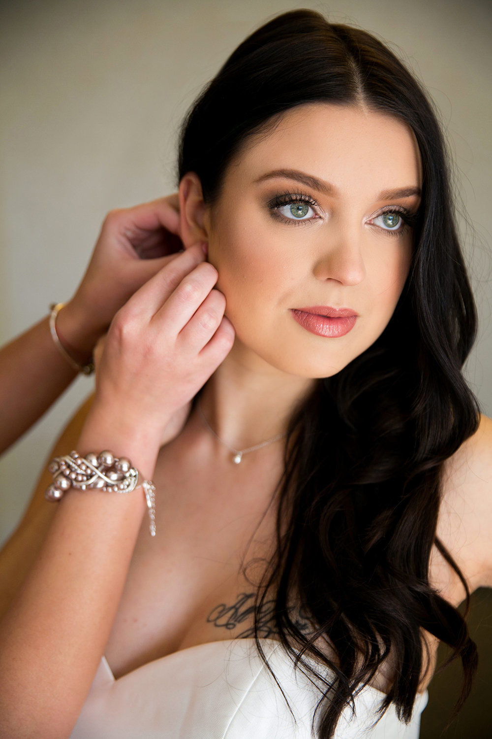 Bride Putting on Earrings