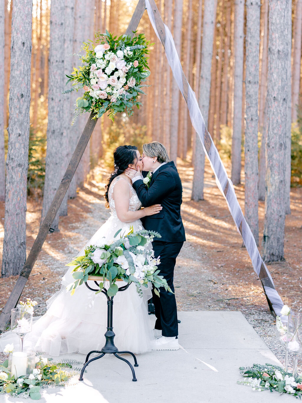 ceremony-kiss-triangle-arch-floral-installation