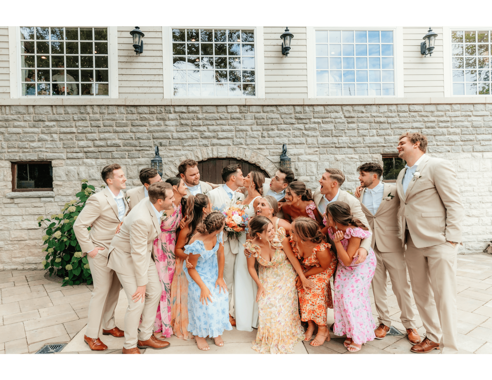 Candid wedding party cheering around joyful couple, colorful and emotional Ohio wedding photography for modern, sentimental couples
