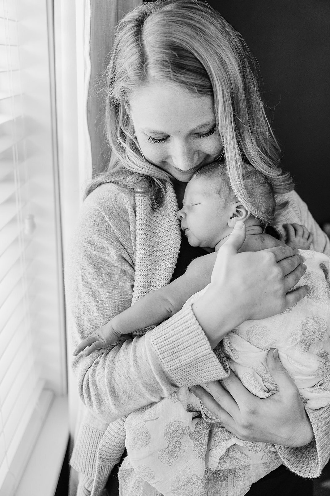 black and white photo of mom and newborn