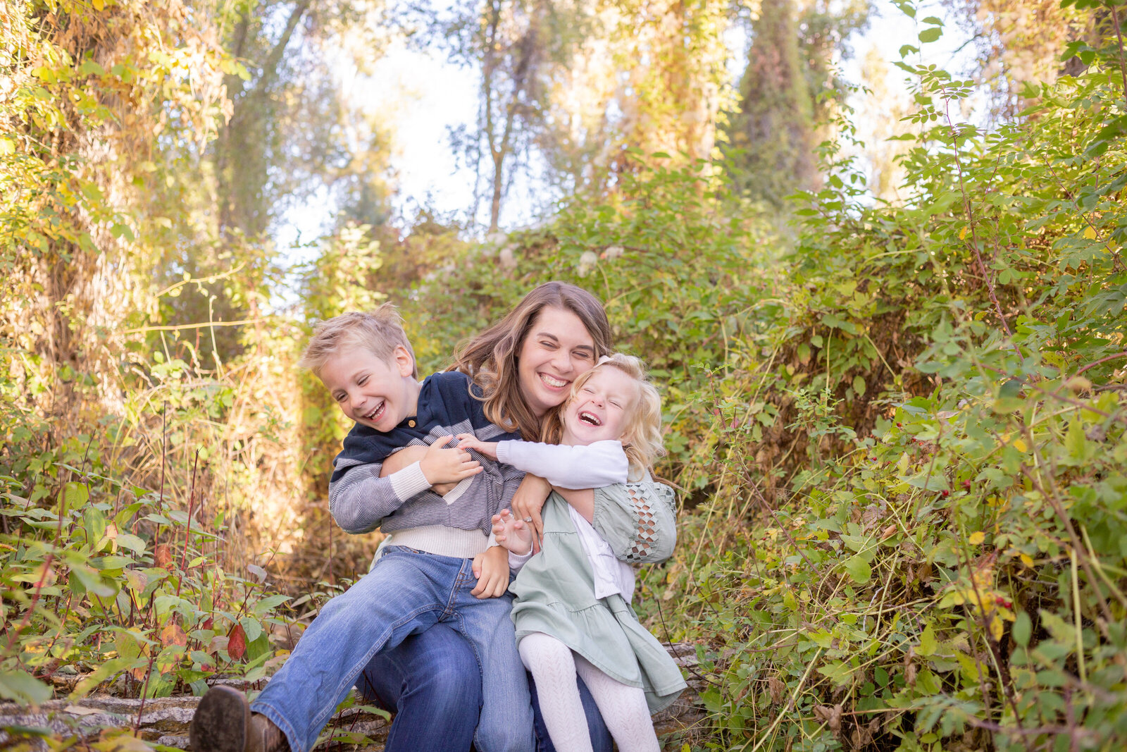 Seattle Wedding Photographer captures mom playing with her kids and laughing