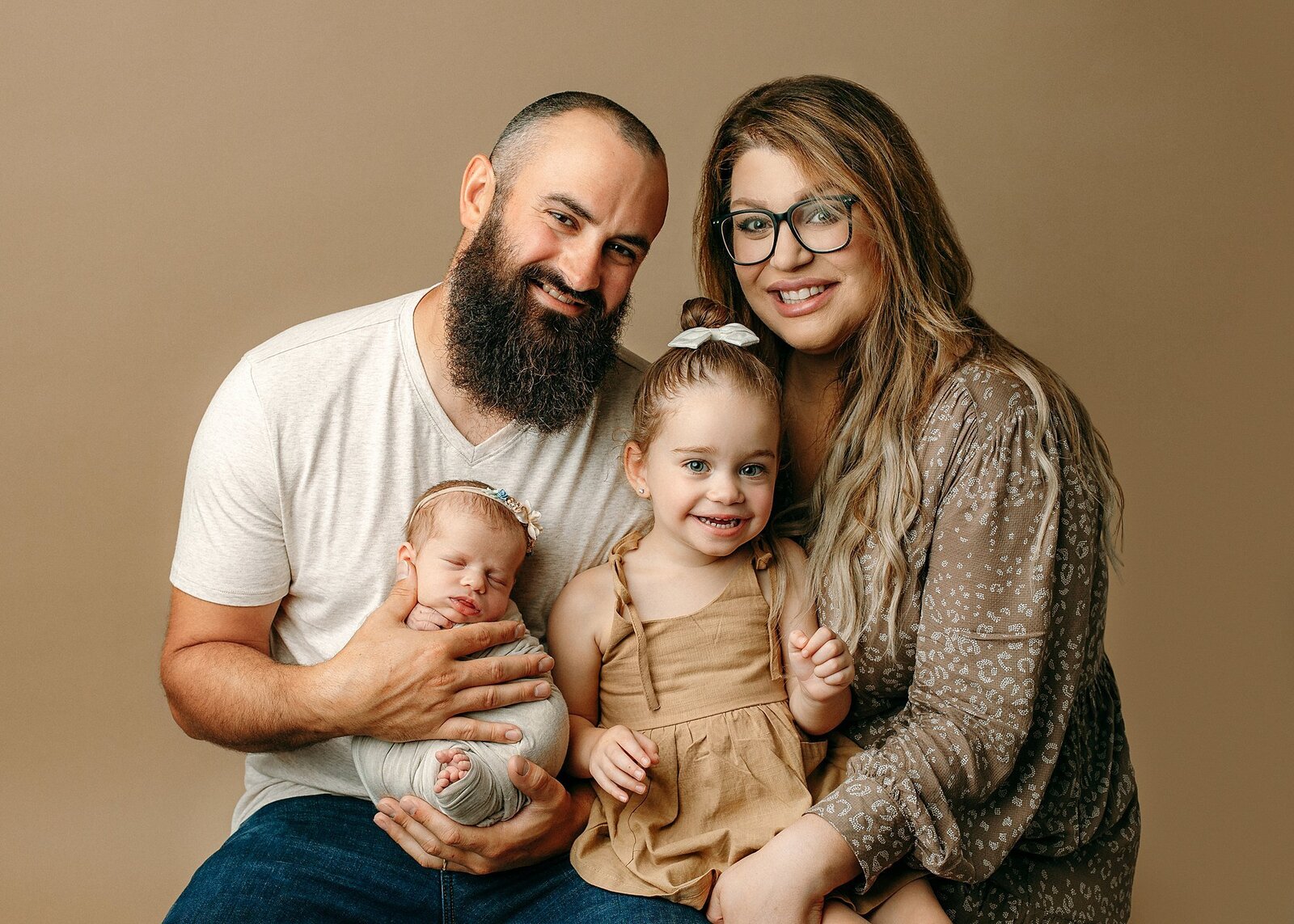 Family posed with newborn baby girl.