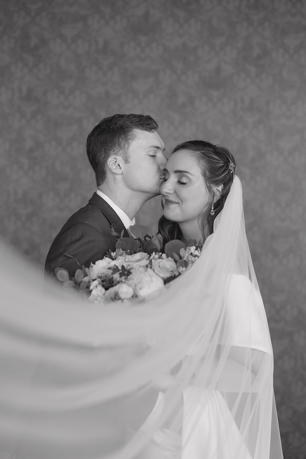 groom-kissing-cheek-wedding-portrait