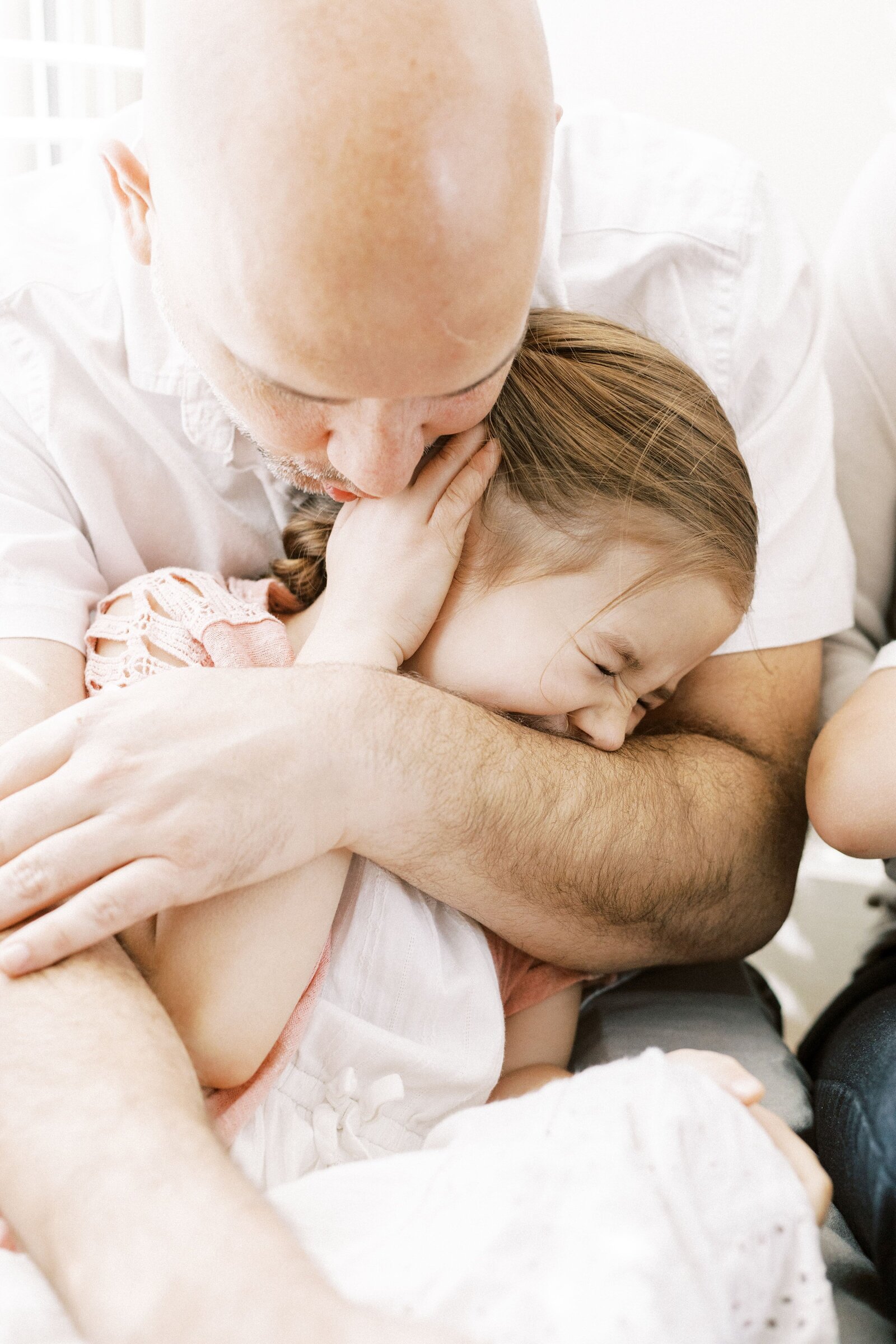 dad hugging child during peoria illinois family photos 
