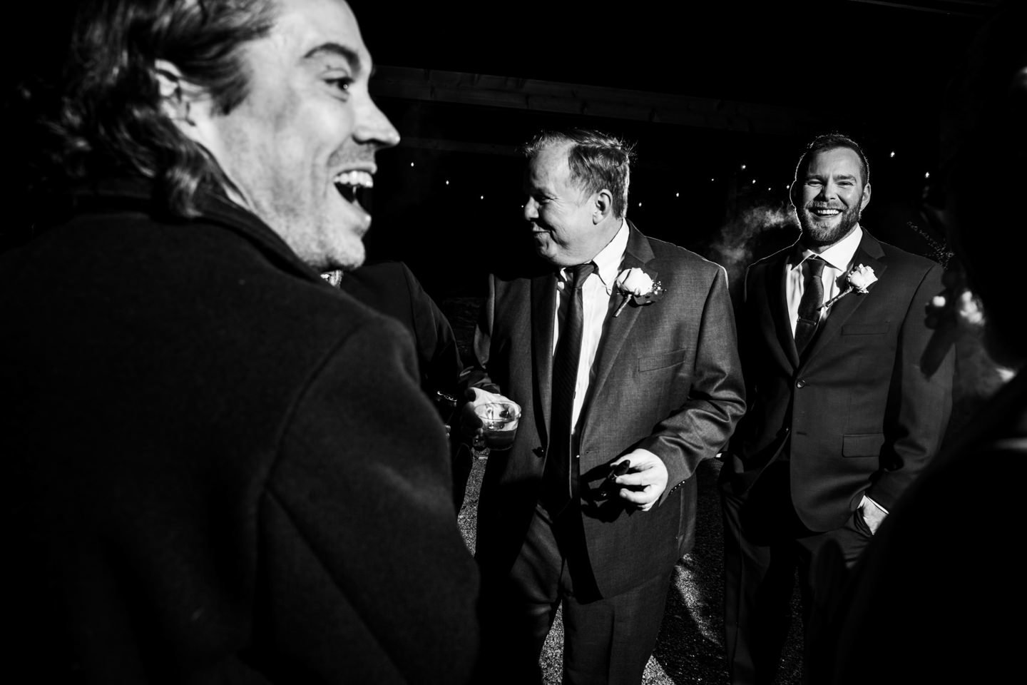 men celebrating with cigars at wedding reception  texas