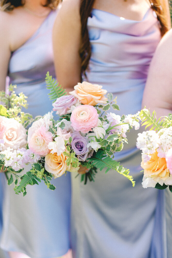 bridesmaids holding purple flowers