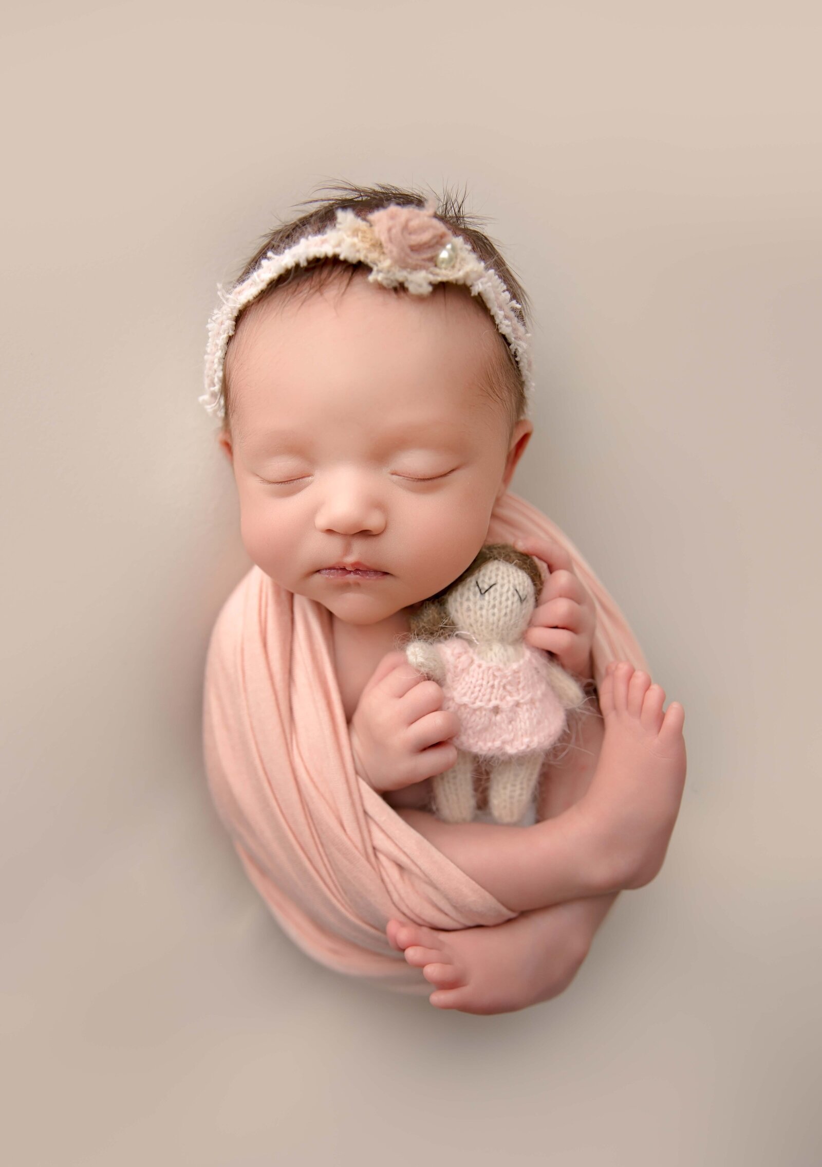 Timeless Studio Newborn Pictures of a Baby Girl Wrapped in Neutrals.jpg