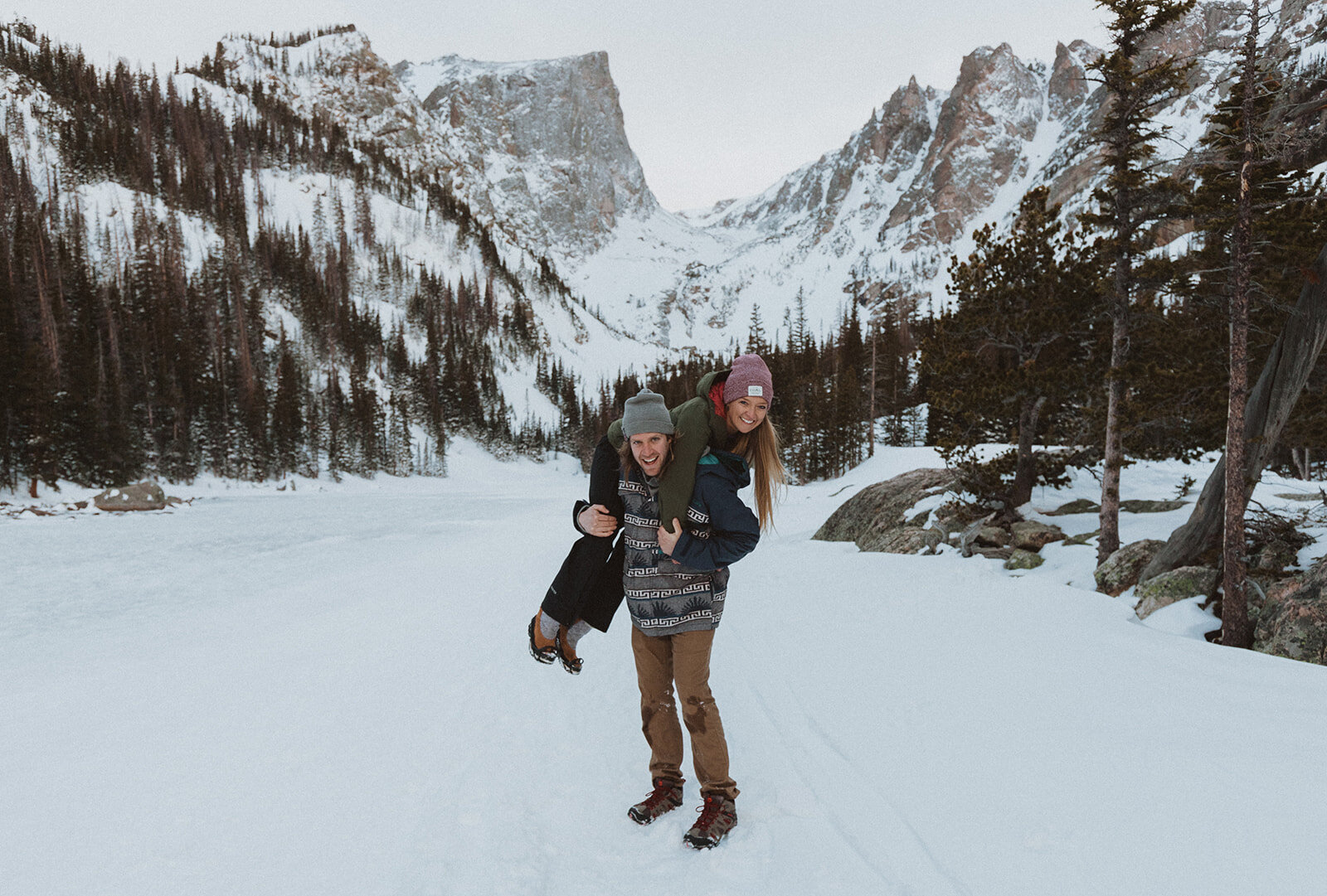 a snowy adventurous engagement session in the rocky mountains