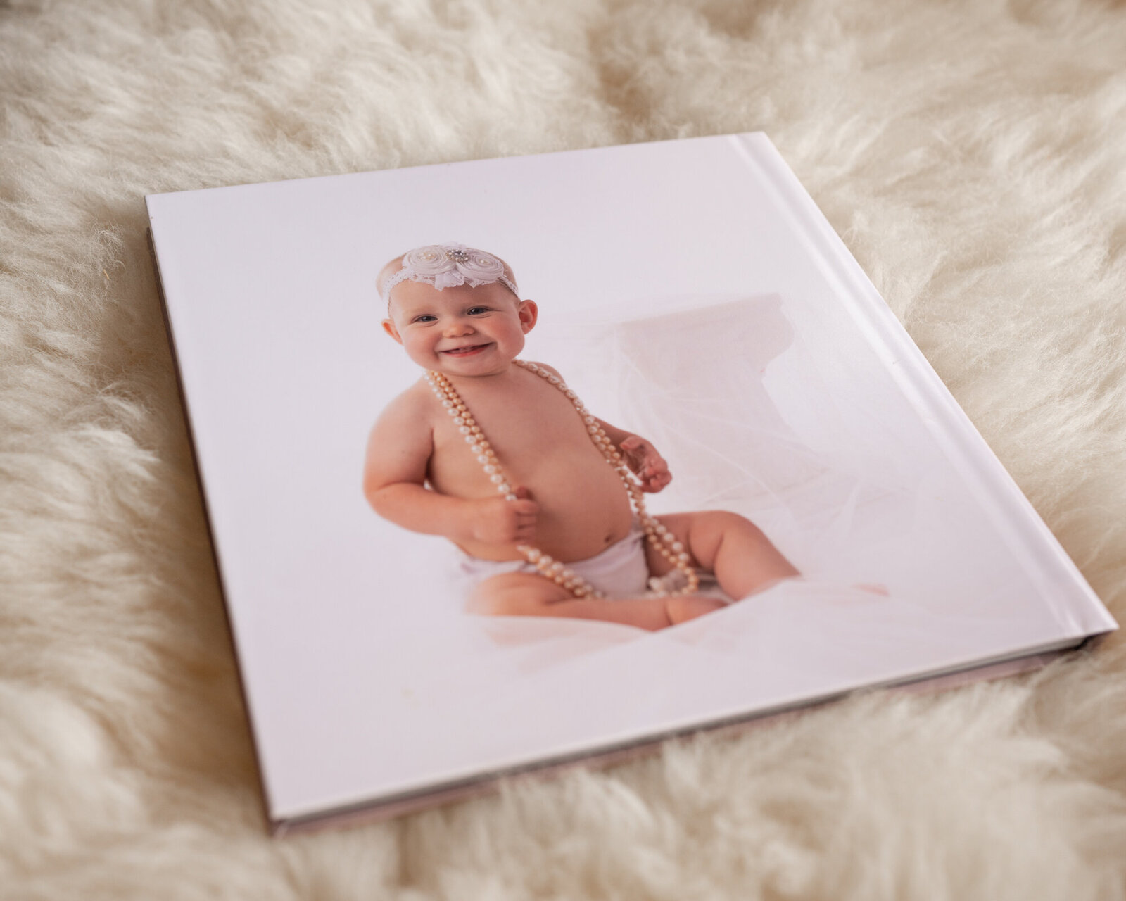 The Back of an album features a girl on white and with a pearl necklace