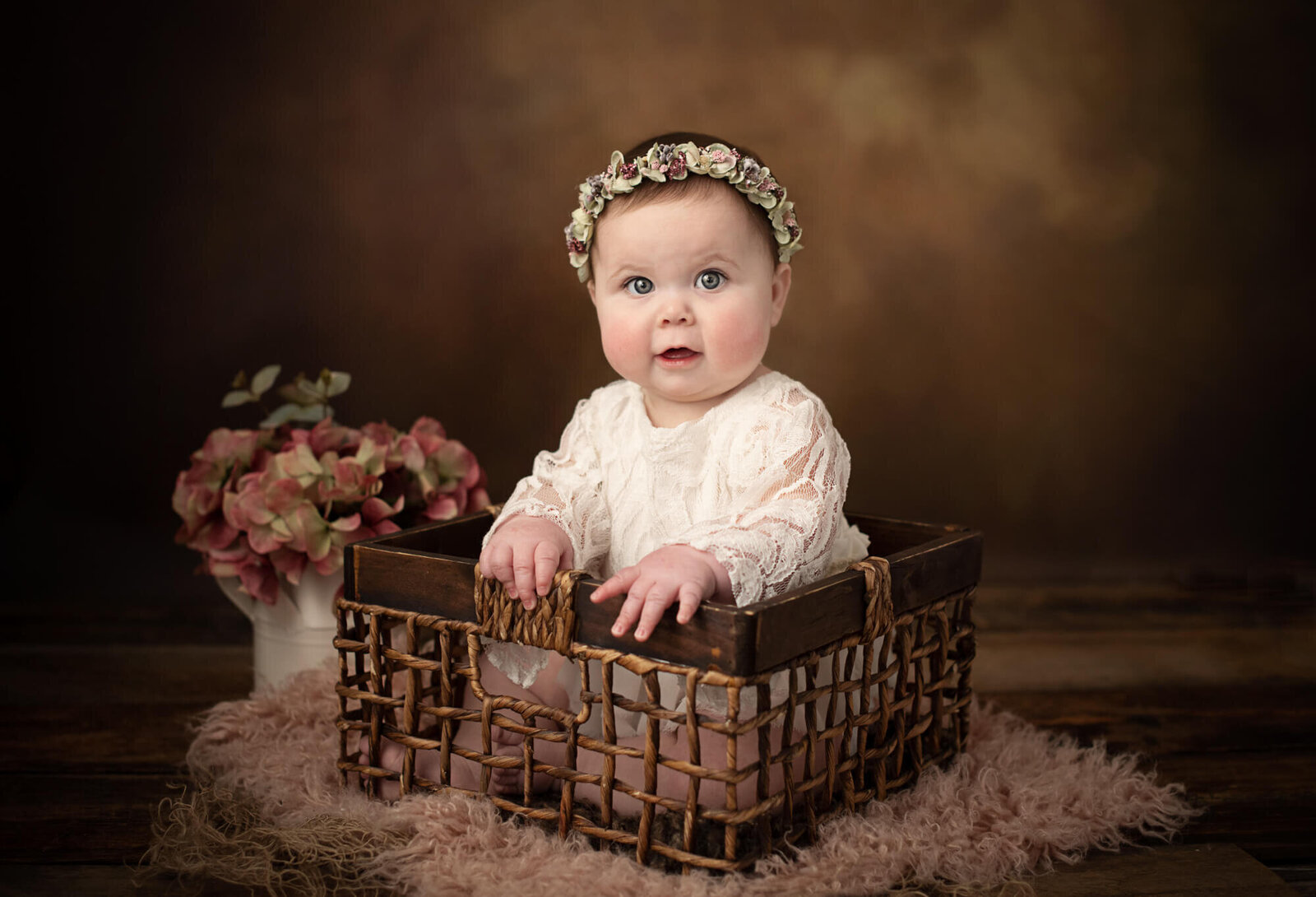 Baby girl with wood background and flowers