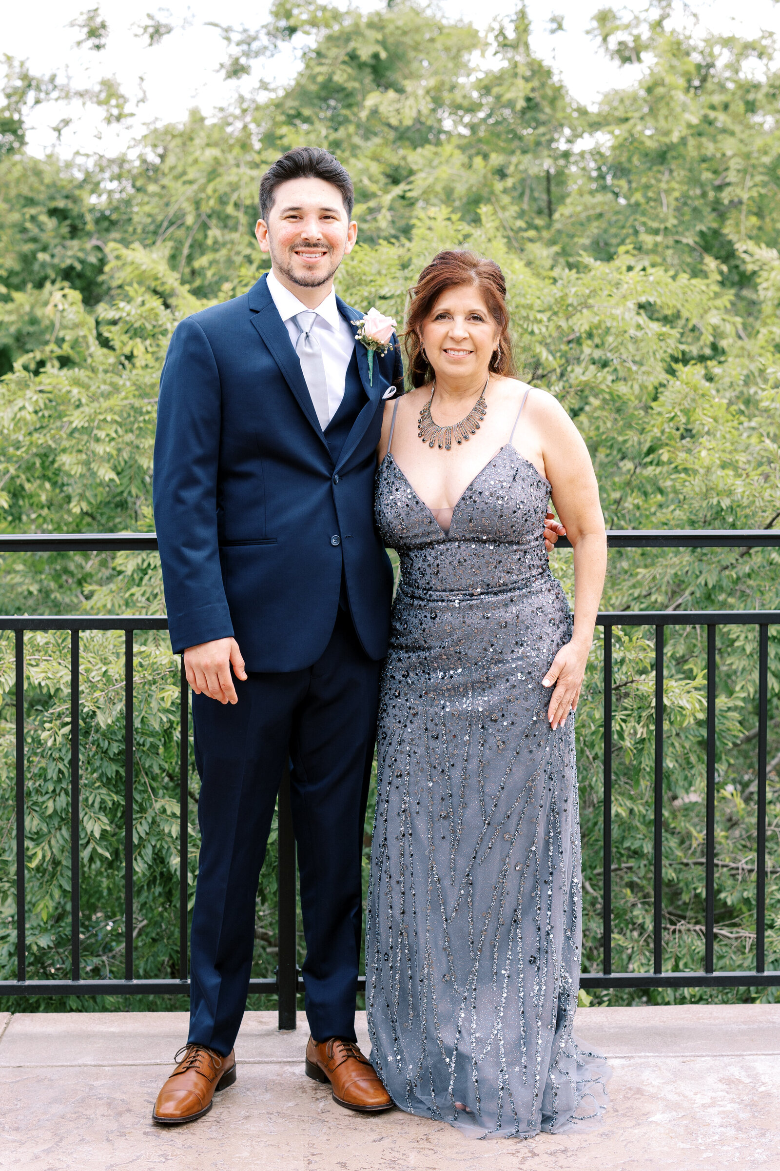 sacramento wedding photographer photographs groom and mother of the groom standing together on a balcony