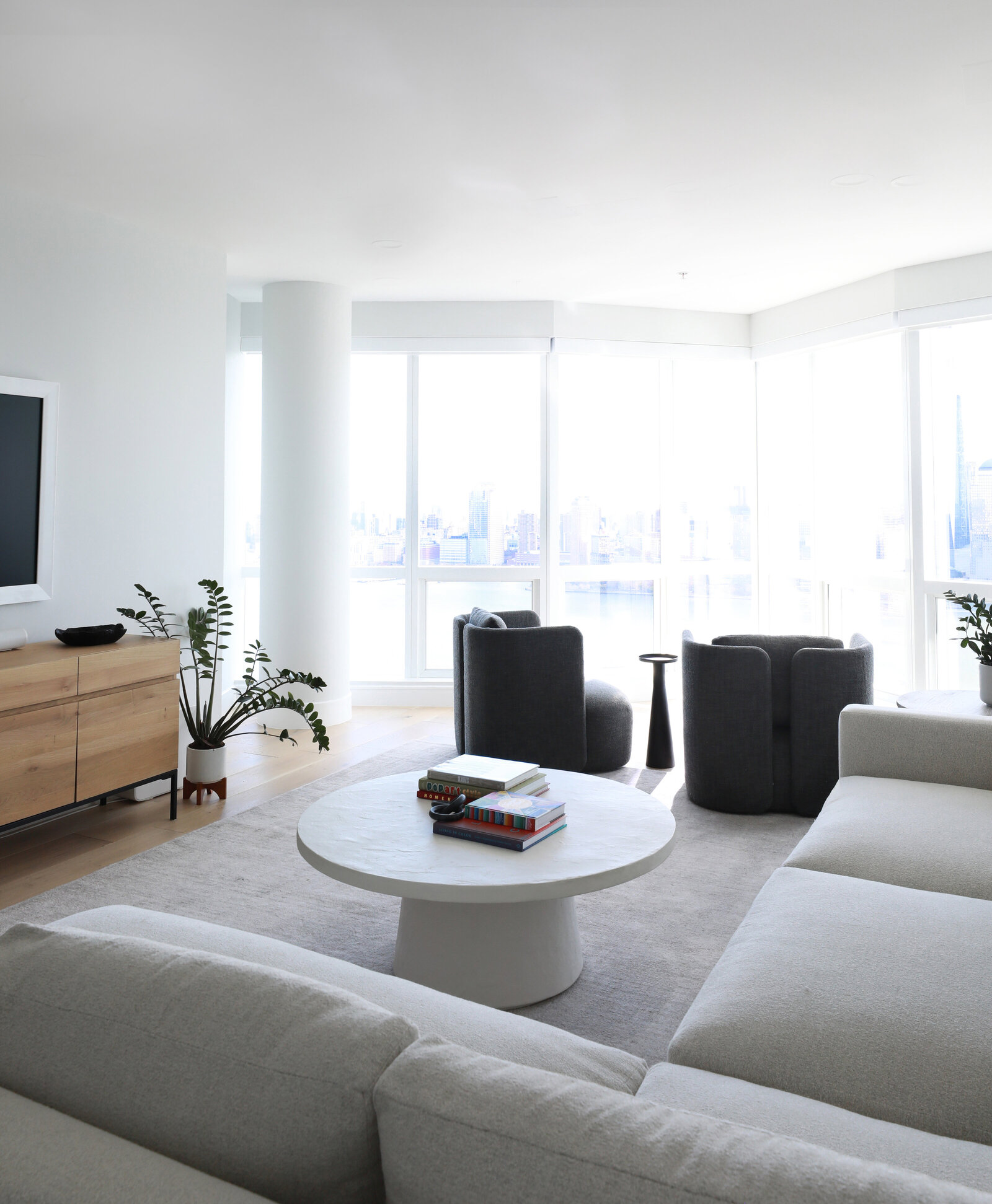 LUXE MODERN LIVING ROOM WITH SECTIONAL SWIVELS AND ART
