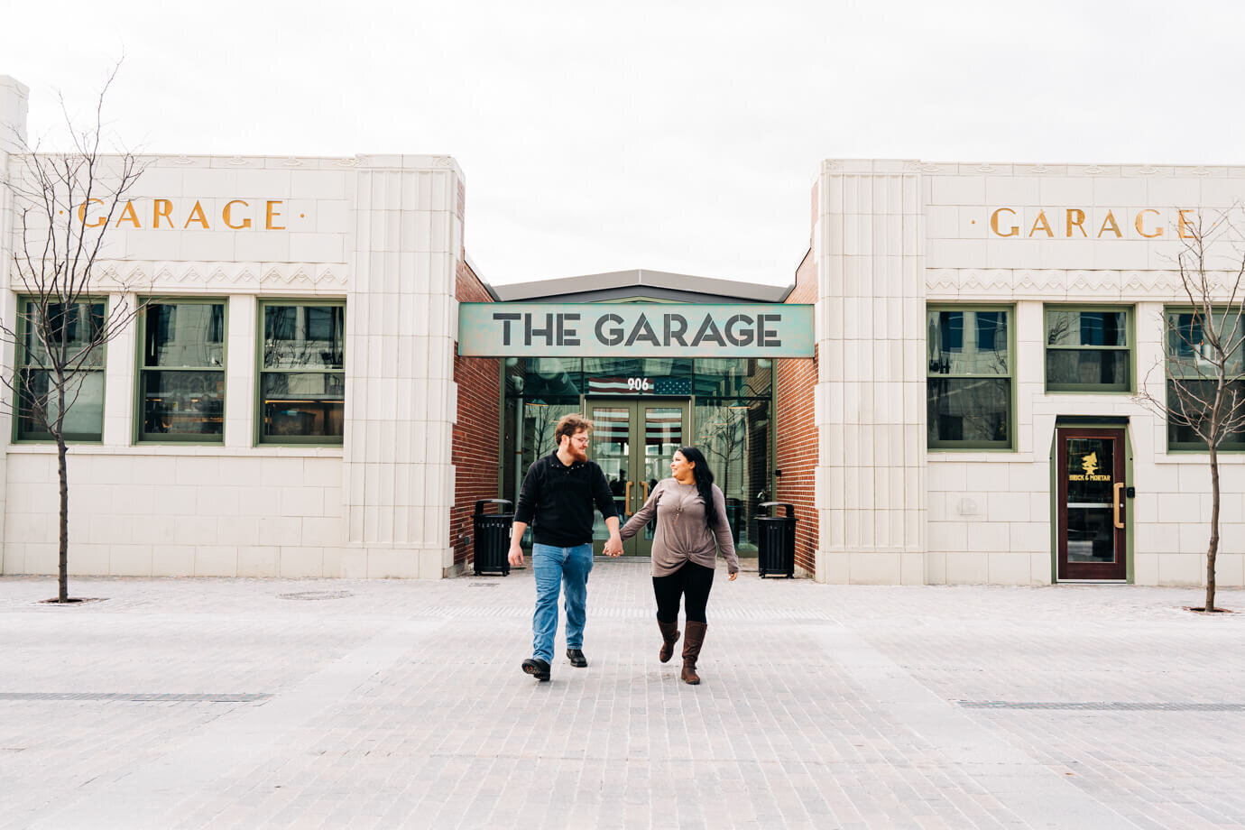 A couple walk with one another during their engagement session at the Bottleworks District in Indianapolis, Indiana.