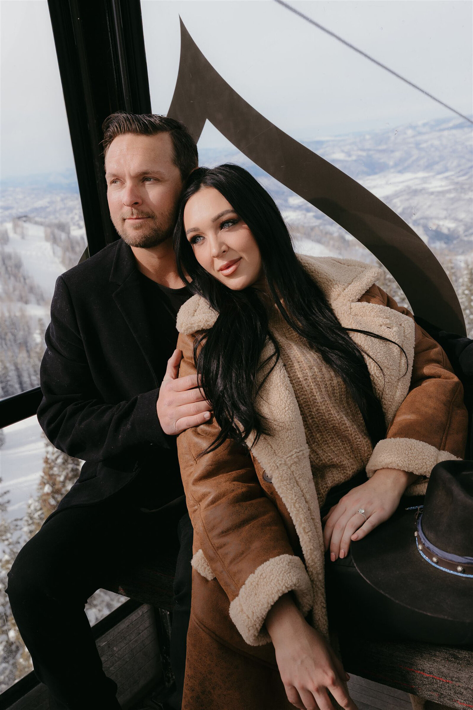 Couple riding gondola during Aspen winter engagement session