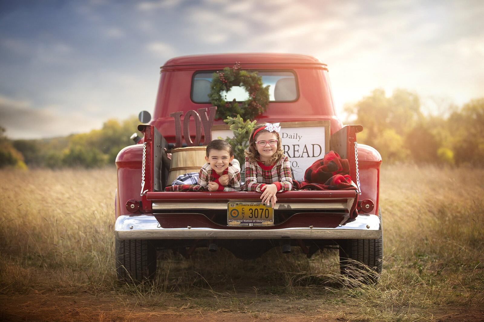 Photos of Plano Siblings in red Christmas truck