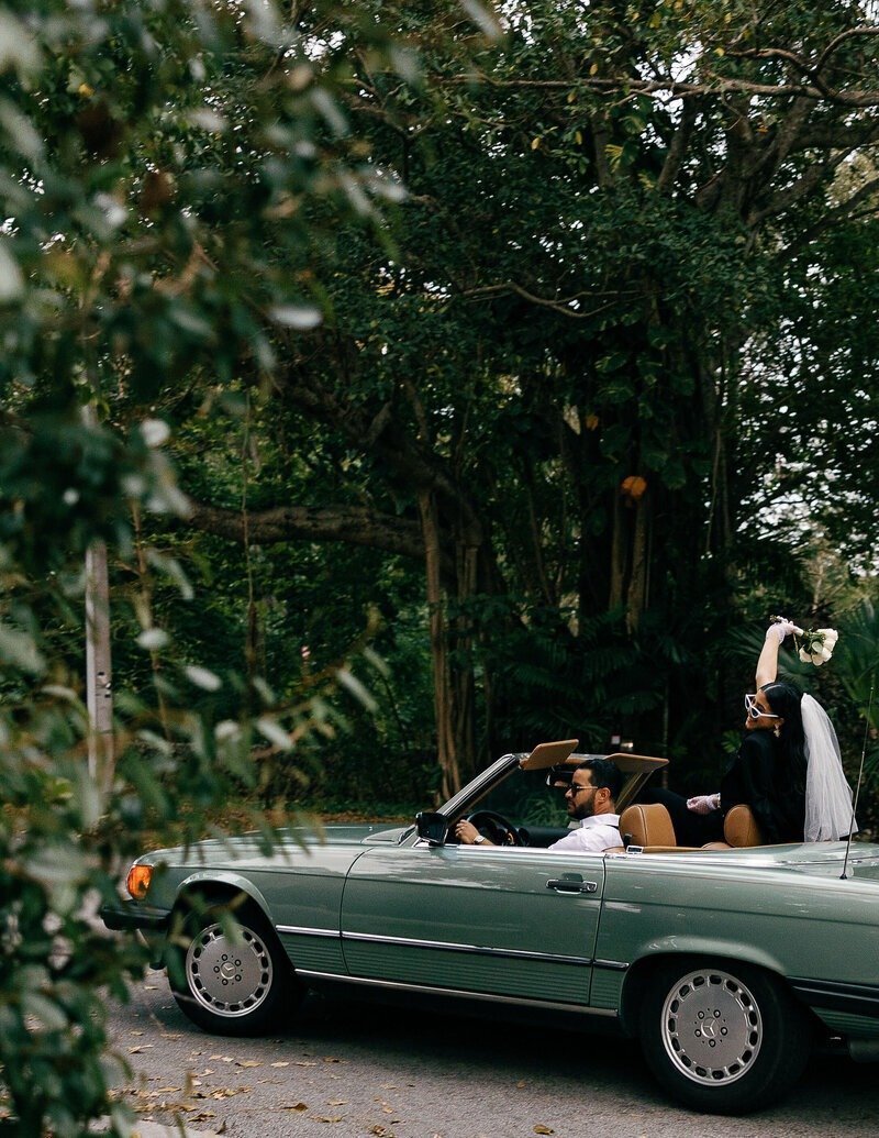 couple in car driving in Naples Florida
