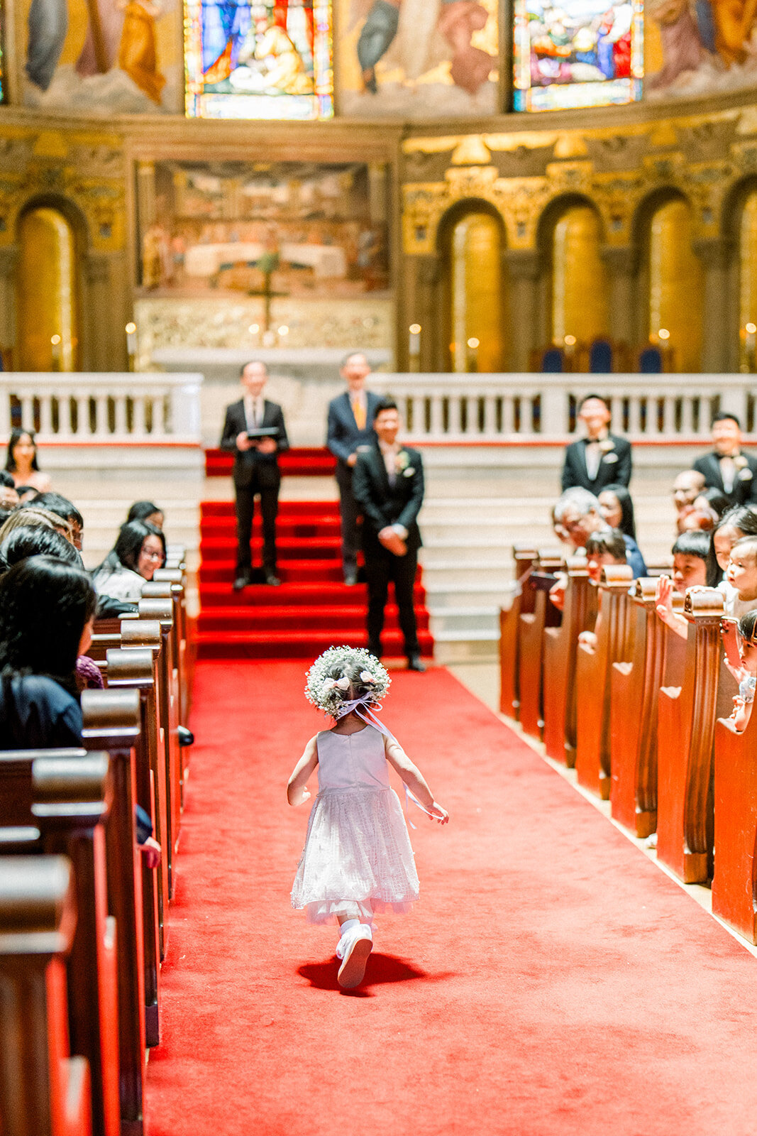 The bride walks down the aisle at Stanford Memorial Church, capturing the beauty and significance of the moment.