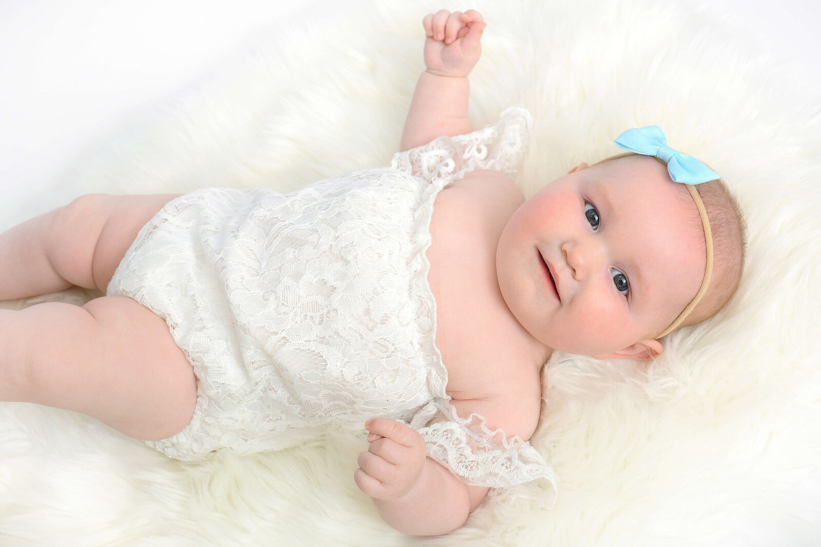 baby smiles at a studio milestone photoshoot