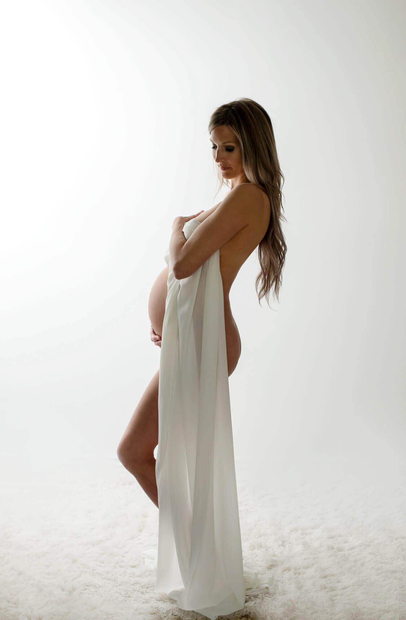 Maternity photo shoot with high key lighting and fabric