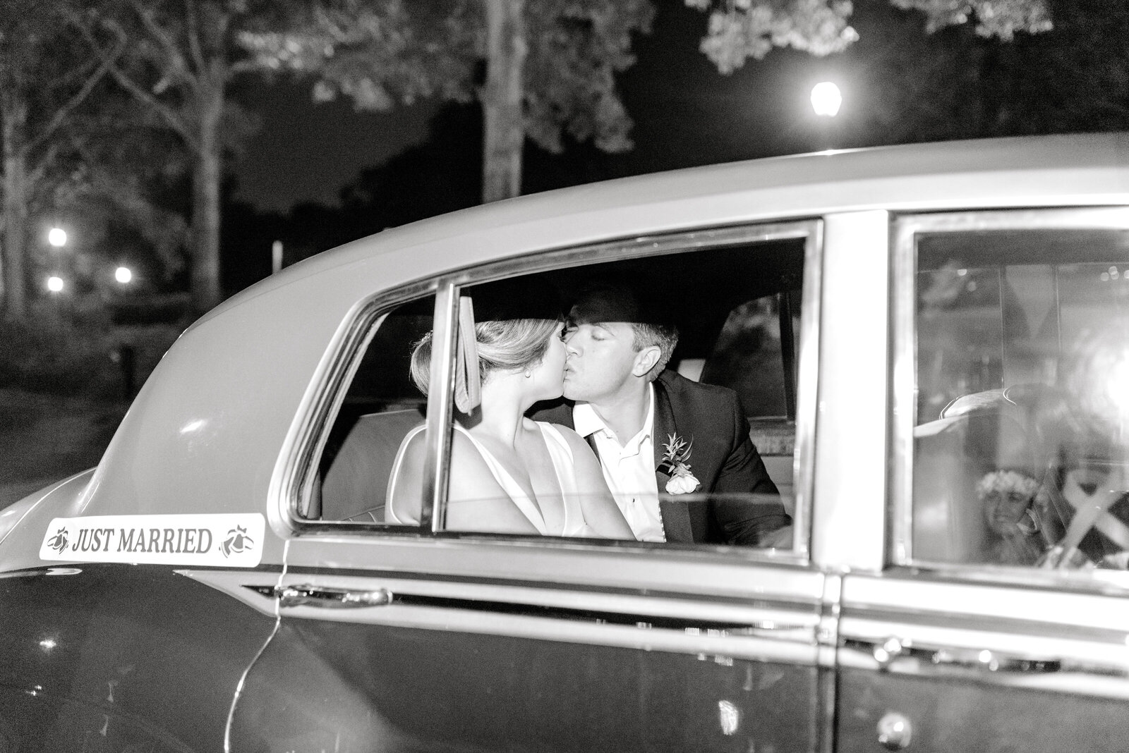 couple in wedding getaway car