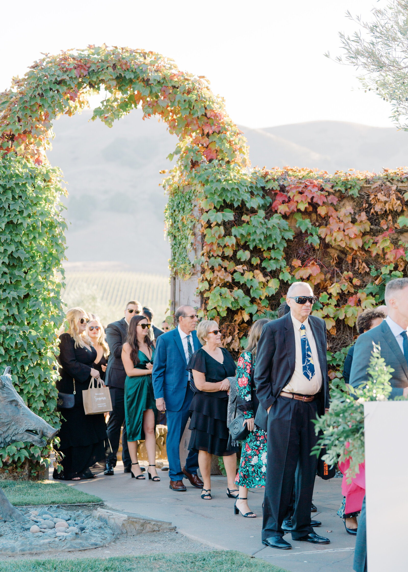 wedding guests heading to the outdoor garden reception