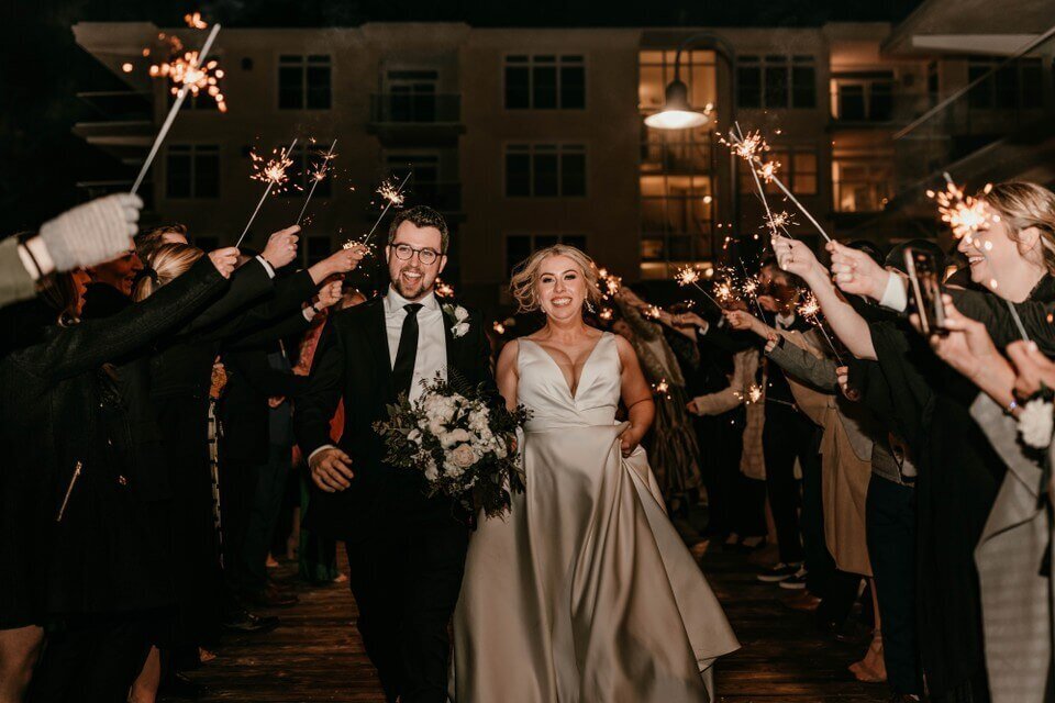 bride and groom happy and running sparkler send off wedding photos in dewey beach delaware