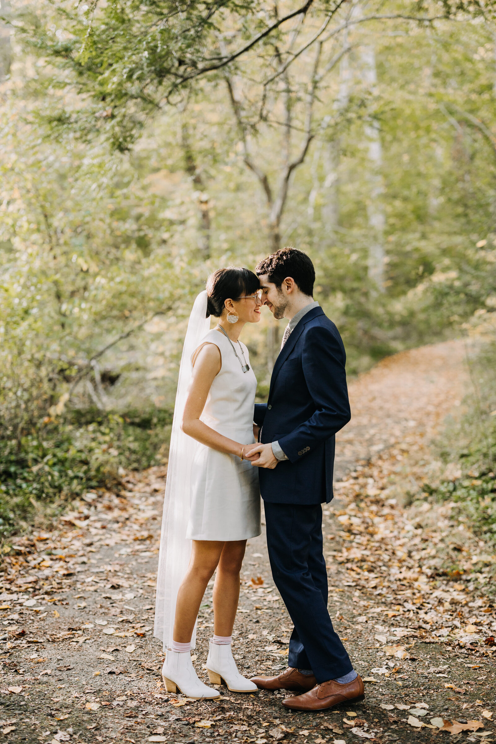 bride with short dress and groom in fall woods