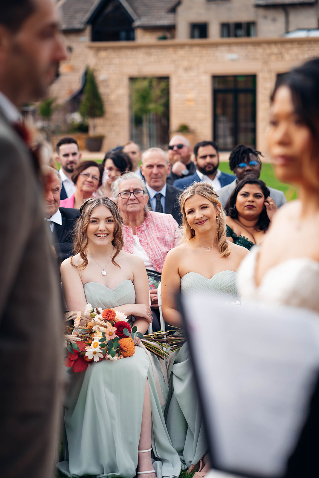 bridesmaids-watching-ring-exchange-during-caslwee-house-wedding-ceremony