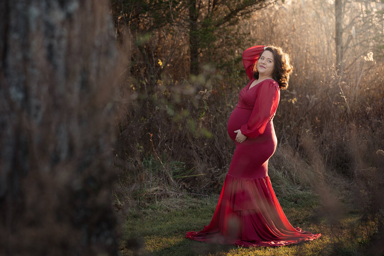 NJ Baby photographer captures expecting mother holding her belly in magical light