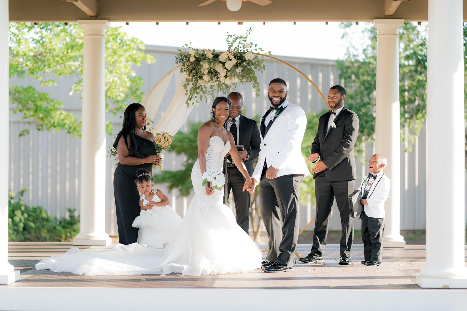 Bride and groom holding each other with entourage