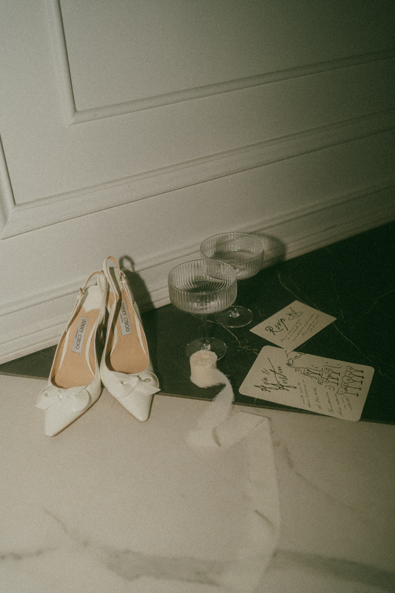 A photo of details from a Nashville wedding day including shoes, invites, and martini glasses.