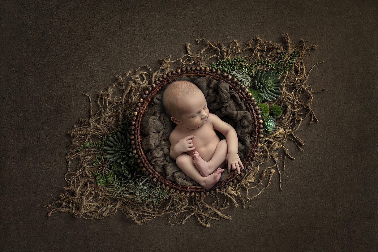 Newborn boy in bowl, a Dallas newborn photographer.