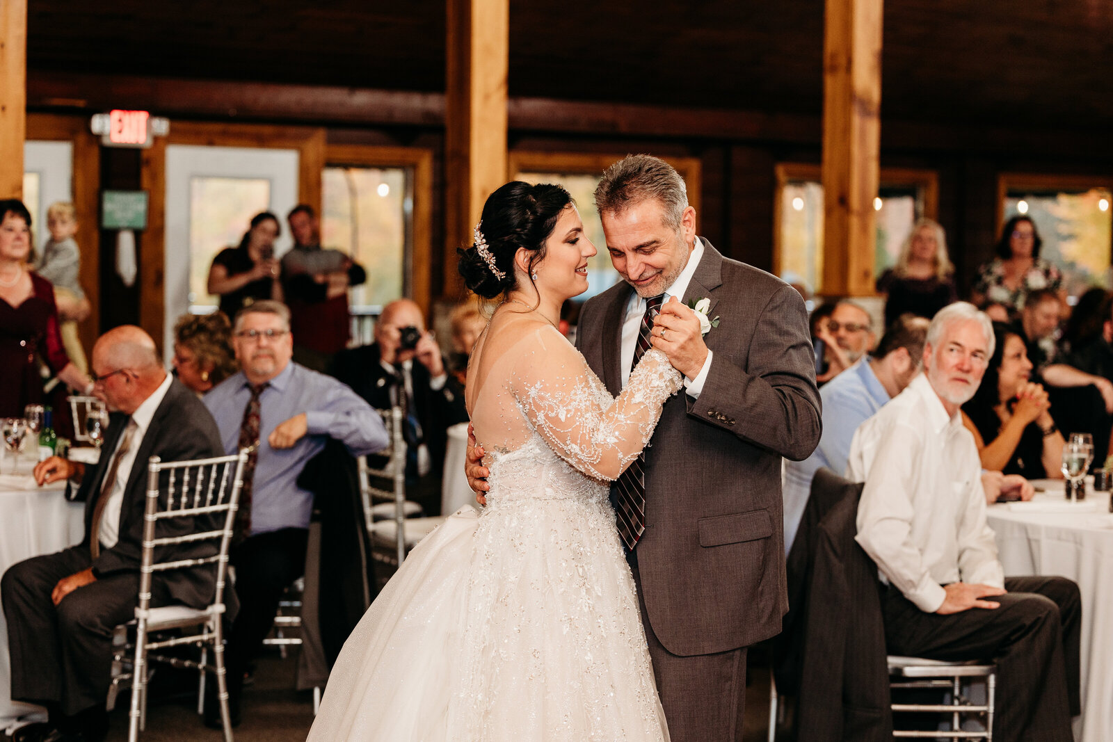 Father and daughter  happily dance together on her wedding day