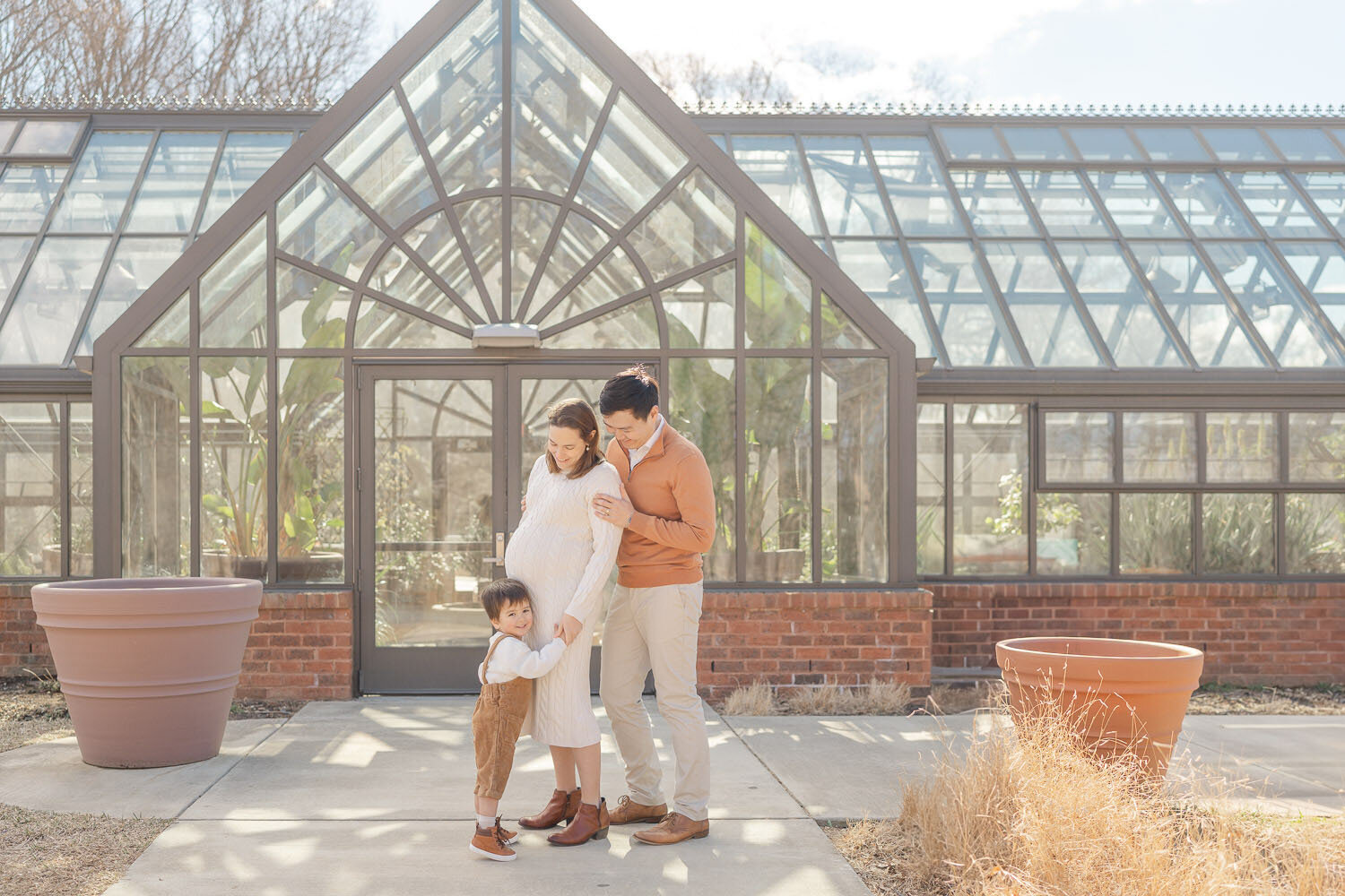 big brother hugging mom's belly during Reston, Virginia maternity session