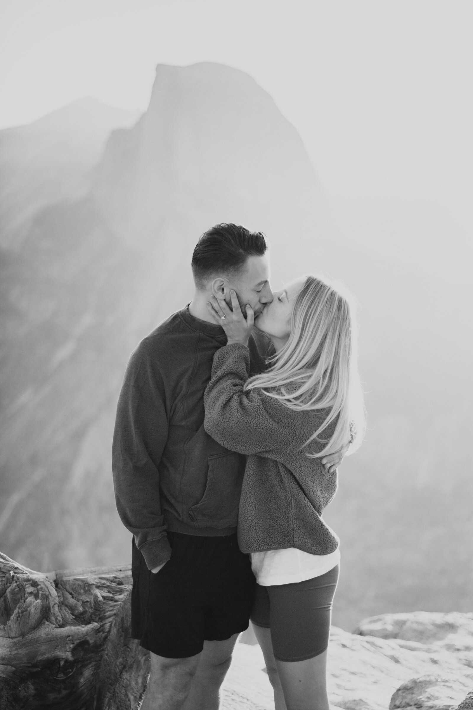 A wedding proposal between two hikers at sunrise in front of Half Dome in Yosemite National Park.