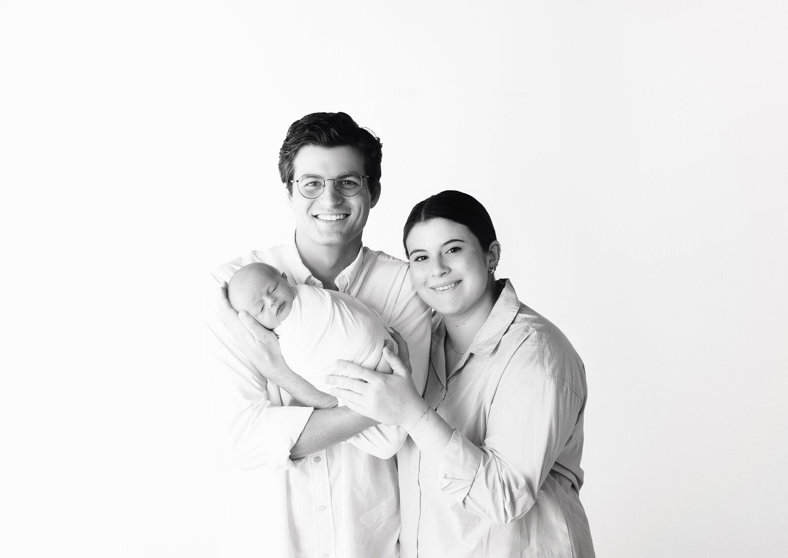 mom and dad holding newborn baby during newborn photoshoot with mt Juliet Tennessee photographer