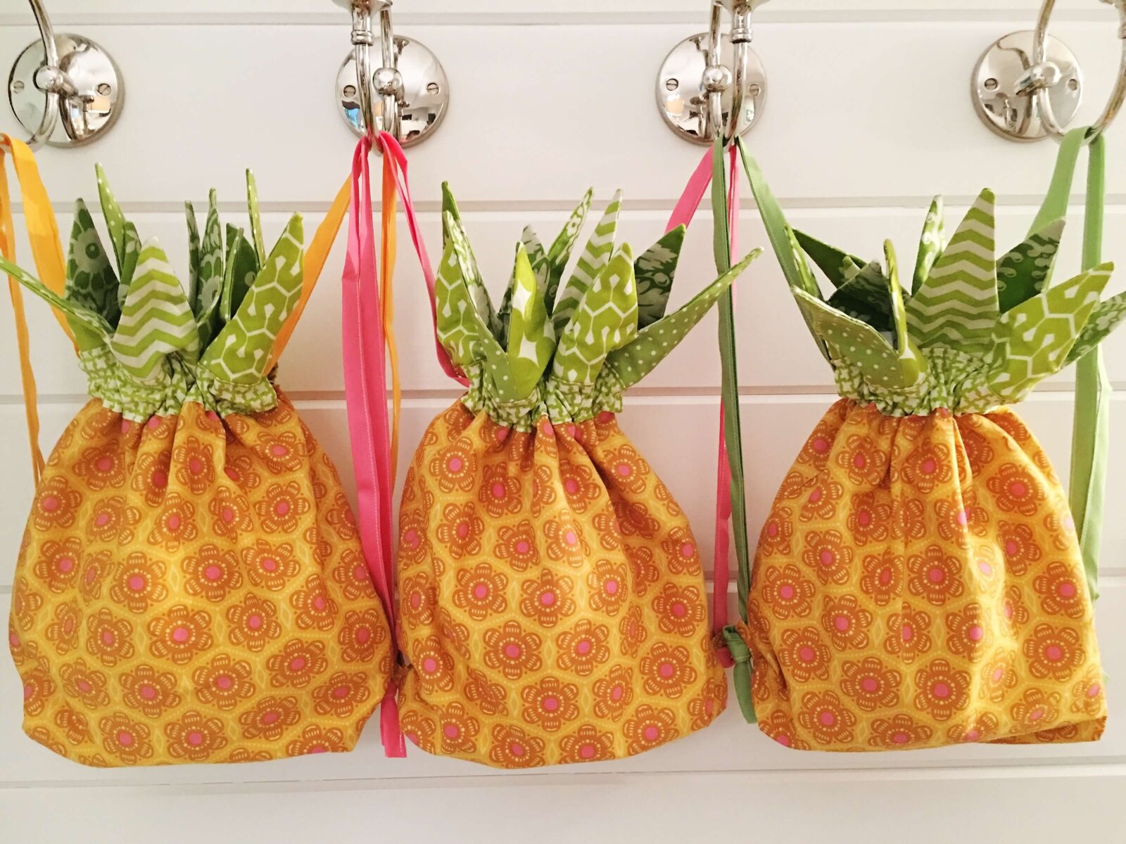 Three hanging bags that look like pineapples