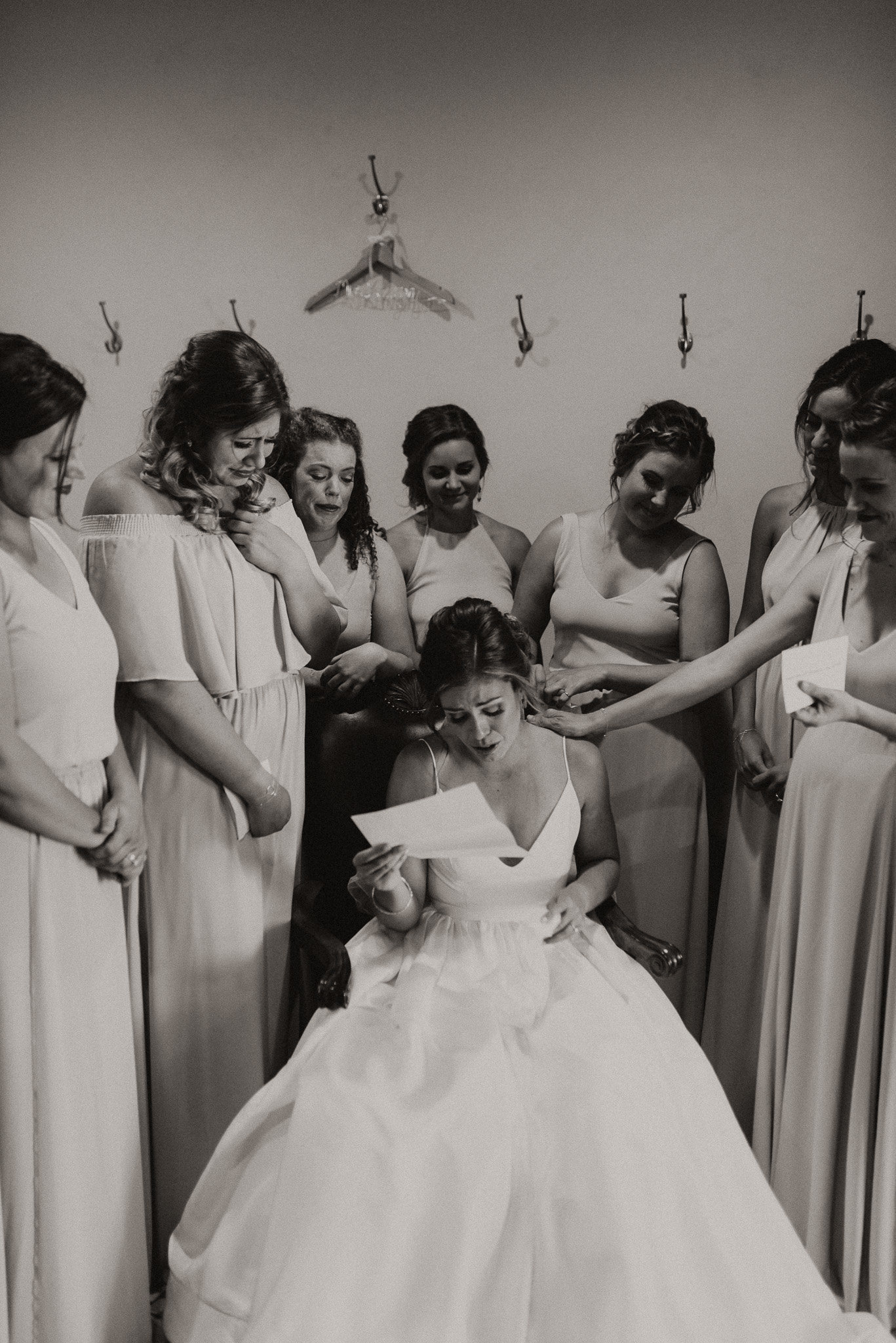 Bride crying and reading a letter from groom. Black and White photo by Sweet Justice photography headquartered in Fort Collins.