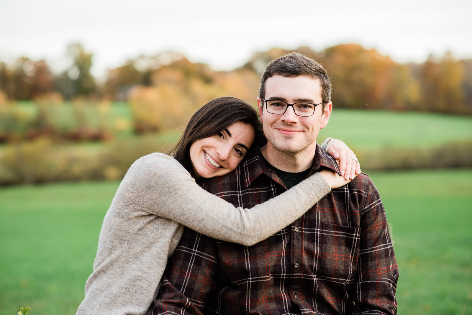 couple sitting and snuggling on farm